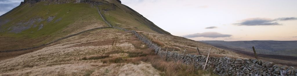 A drystone wall leading up a hill in the Yorkshire Dales. A drystone wall leading up a hill in the Yorkshire Dales.